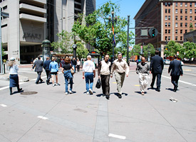 pedestrians crossing at busy intersection on Market Street