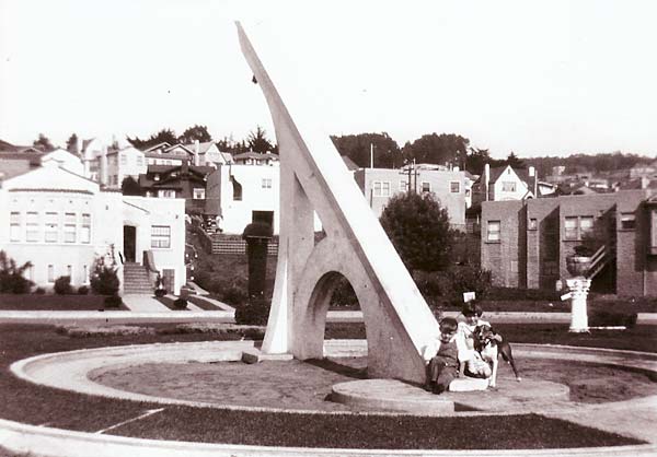 children sitting in front of large sun dial circa 1926